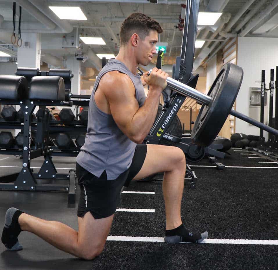 Fit squad client doing a kneeling landmine press at our gym